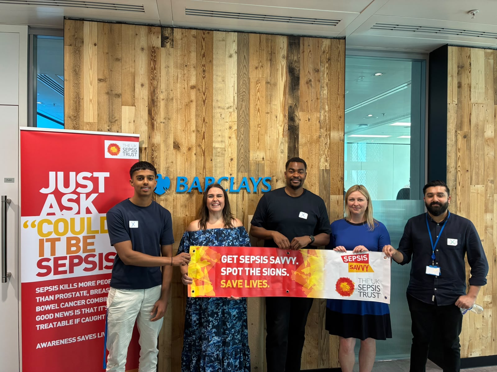 A group shot of people wearing UK Sepsis Trust branded clothing.
